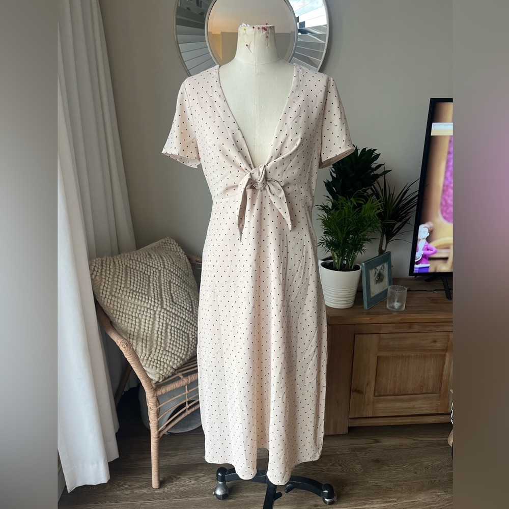 Brand new. Never worn. nude and navy polka dot tie front dress size large